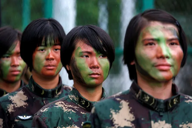 People's Liberation Army soldiers stand in line before a performance during an open day at a naval base in Hong Kong, China July 8, 2017. (Photo by Bobby Yip/Reuters)