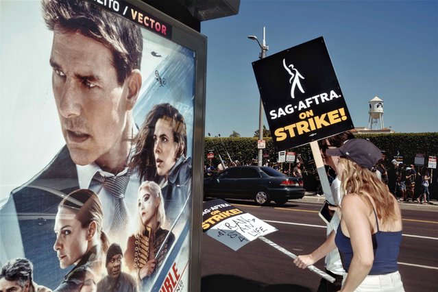 Members of the Screen Actors Guild and the Writers Guild of America picket outside Paramount Pictures in Los Angeles on Friday, July 14, 2023. Hollywood actors and writers are on strike simultaneously for the first time in more than 60 years, bringing most film and television productions to a halt. (Photo by Mark Abramson/The New York Times/Redux)