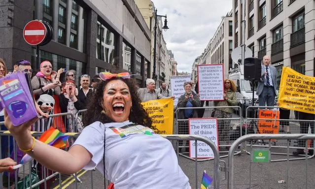 A participant at London Pride 2022 parade takes a mocking selfie next to Christian extremists protesting the parade in Piccadilly on July 2, 2022. (Photo by Vuk Valcic/ZUMA Press Wire/Rex Features/Shutterstock)