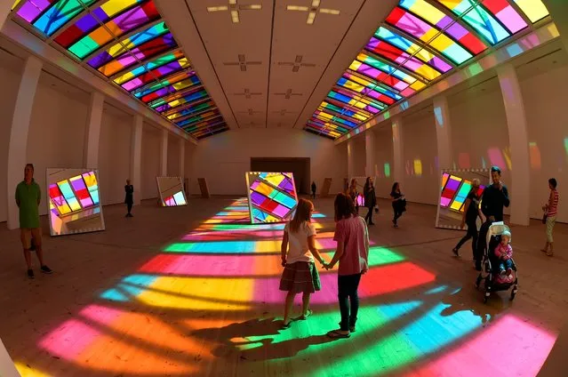 A light show by French artist Daniel Buren called Catch, which is on display at the Baltic Arts centre in Gateshead, on August 6, 2014. Sunlight hits 10 mirrors and reflects different coloured vinyl from the skylight. (Photo by Owen Humphreys/PA Wire)