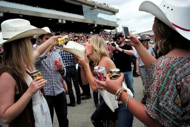 Rodeo fans party in the grandstands during the Calgary Stampede rodeo in Calgary, Alberta, Canada July 9, 2016. (Photo by Todd Korol/Reuters)