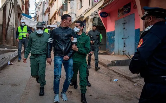 Moroccan authorities arrest a man who refused to remain in confinement as security forces instruct people to return to and remain at home as a measure against the COVID-19 coronavirus pandemic, in the capital Rabat's district of Takadoum, on March 27, 2020. (Photo by Fadel Senna/AFP Photo)