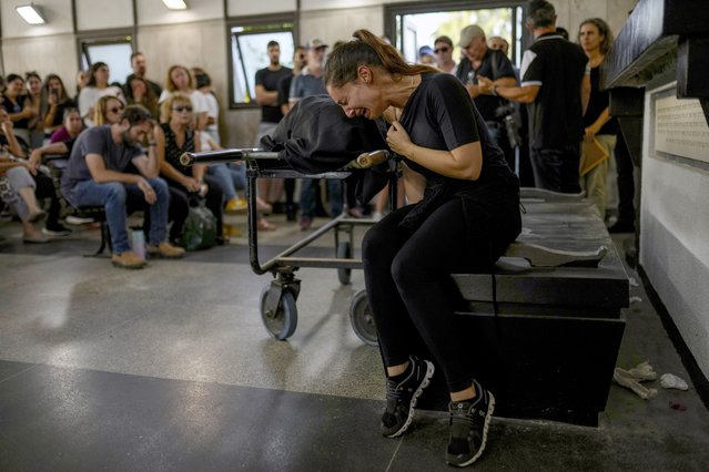 Mourners react beside the body of Mapal Adam, during her funeral in Tel Aviv, Israel, Wednesday, October11, 2023. Adam was killed by Hamas militants on Saturday as they carried out an unprecedented, multi-front attack that killed over 1,000 Israelis. (Photo by Francisco Seco/AP Photo)