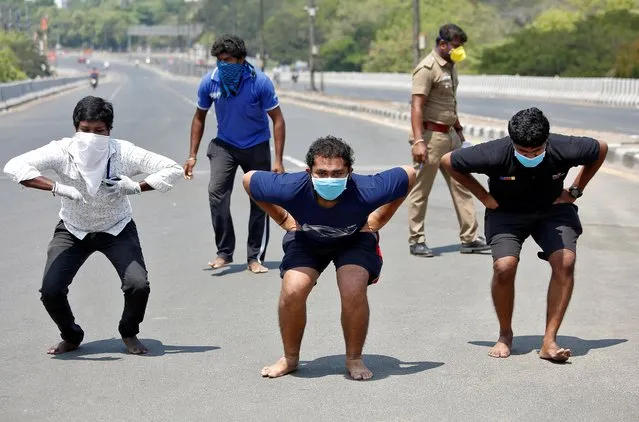 People squat barefoot as a punishment for breaking a lockdown imposed to slow the spreading of coronavirus disease (COVID-19) in Chennai, India, April 1, 2020. (Photo by P. Ravikumar/Reuters)