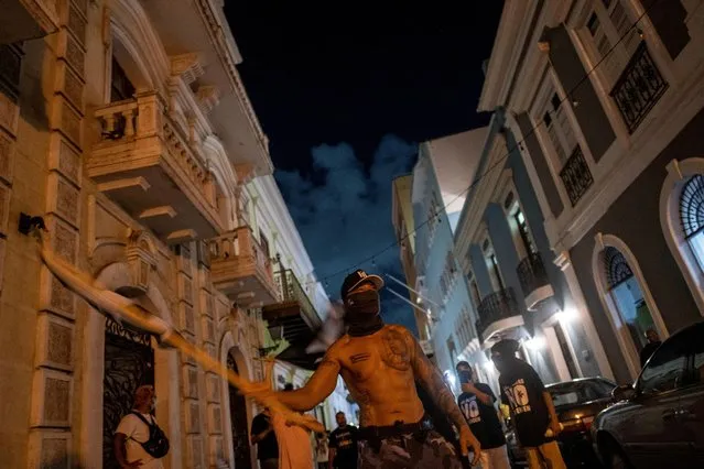 Demonstrators protest near the executive mansion following a protest to demand the cancellation of electricity grid operator LUMA Energy's contract in San Juan, Puerto Rico on August 25, 2022. (Photo by Ricardo Arduengo/Reuters)