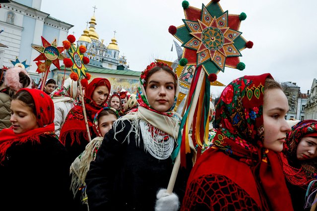 People wear traditional Ukrainian clothes as they mark Christmas Day with a carol singing event outside St. Michael's Golden-Domed Monastery, amid Russia's attack on Ukraine, in Kyiv, Ukraine, on December 25, 2024. (Photo by Thomas Peter/Reuters)