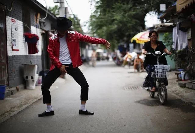 Zhang Guanhui, impersonating Michael Jackson, dances in front of his house located in a village for migrant workers during an interview with Reuters in Beijing July 22, 2014. (Photo by Kim Kyung-Hoon/Reuters)
