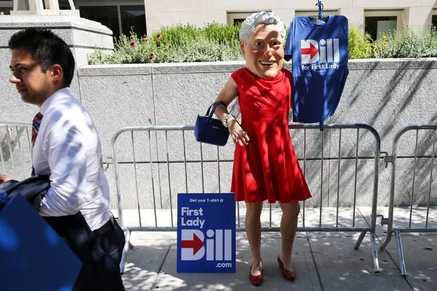 A vendor sells shirts wearing a Bill Clinton mask and red dress outside the Pennsylvania Convention Center on the second day of the Democratic National Convention in Philadelphia, Pennsylvania, U.S., July 26, 2016. (Photo by Dominick Reuter/Reuters)