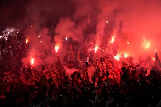 Fans of Brazil's Sao Paulo cheer and light flares as they wait for the start of a Copa Sudamericana semifinal first leg soccer match against Brazil's Atletico Goianiense in Goiania, Brazil, Thursday, September 1, 2022. (Photo by Eraldo Peres/AP Photo)