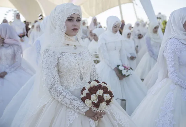 199 brides (marking the city's 199th birthday) gather in Tsvetochny Park to get married on Grozny City Day in Chechen Republic, Russia on October 5, 2017. (Photo by Yelena Afonina/TASS)