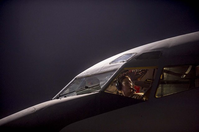 In this photo released today, Maj. Gena Fedoruk, a KC-135 Stratotanker pilot with the 340th Expeditionary Air Refueling Squadron, pre-flights her aircraft before taking off from a base in the U.S. Central Command area of responsibility in support of a mission conducting airstrikes in Syria on September 23, 2014. (Photo by Matthew Bruch/U.S. Air Force)