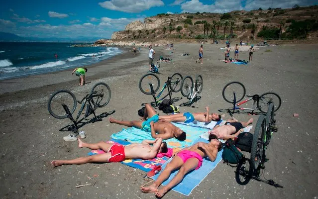 People sunbathe at La Arana Beach in Malaga on June 7, 2020, as lockdown measures are eased during the novel coronavirus COVID-19 pandemic. (Photo by Jorge Guerrero/AFP Photo)