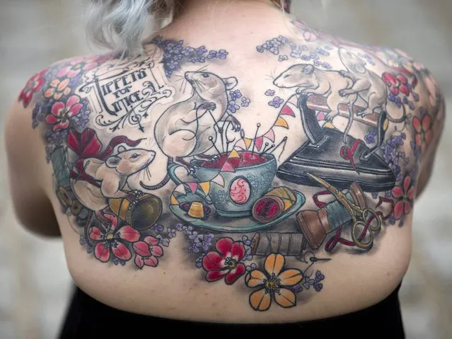 A woman displays her back tattoo at the London Tattoo Convention in London on September 28, 2014. (Photo by Justin Tallis/AFP Photo)