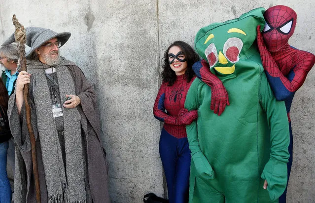 Costumed participants (L-R) Tim Fisher of Nyack, New York, Brianna Acevedo, Lucas Stellino and Julian Barillas, all of Queens New York, pose while arriving for the 2014 New York Comic Con in New York, New York, USA, 09 October 2014. The annual event offers pop culture fans exhibitors and displays of popular video games, movies and comic books and many people attending dress as their favorite character. (Photo by Justin Lane/EPA)