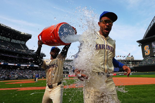 Seattle Mariners' Victor Robles, left, dunks water on teammate Julio RodrÌguez, right, to celebrate a 2-1 win over the Athletics after a baseball game Sunday, March 30, 2025, in Seattle. (Photo by Lindsey Wasson/AP Photo)