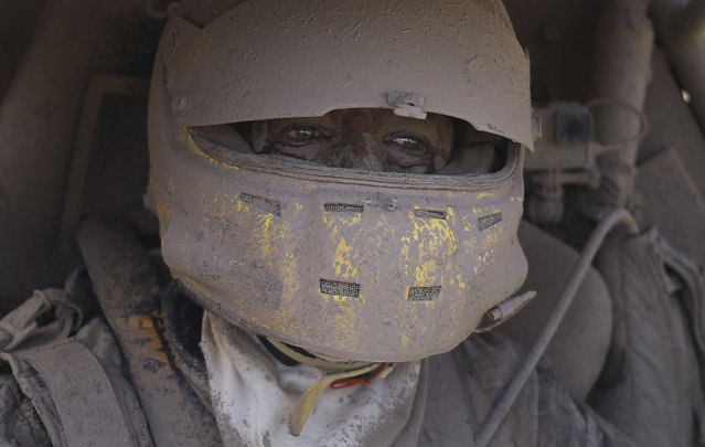 Suzuki car driver Tim Coronel, of the Netherlands, is covered in dirt after completing the second stage of the Dakar Rally between Resistencia and San Miguel de Tucuman, Argentina, Tuesday, January 3, 2017. The race started in Paraguay and passed through Bolivia as well. (Photo by Martin Mejia/AP Photo)