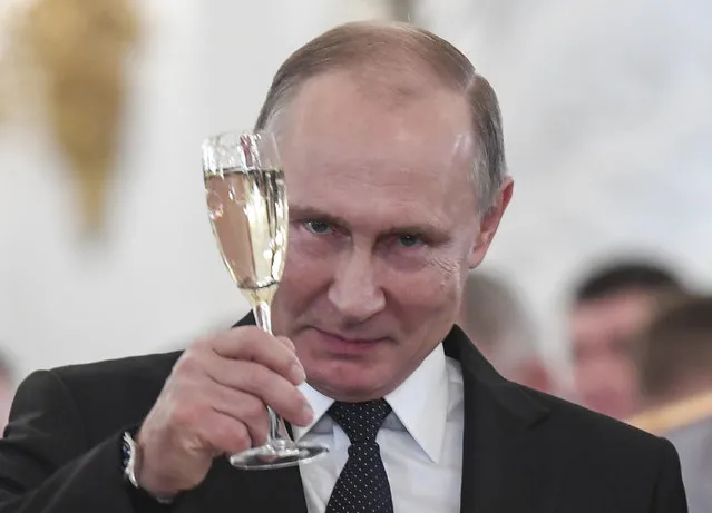 Russian President Vladimir Putin makes a toast during an award ceremony in the Kremlin, in Moscow, Russia, Thursday, December 28, 2017, for Russian Armed Forces service personnel who took part in the anti-terrorist operation in Syria. Putin said at Thursday's award ceremony that Wednesday's explosion at a supermarket in the country's second-largest city was a terrorist attack. (Photo by Kirill Kudryavtsev/Pool Photo via AP Photo)