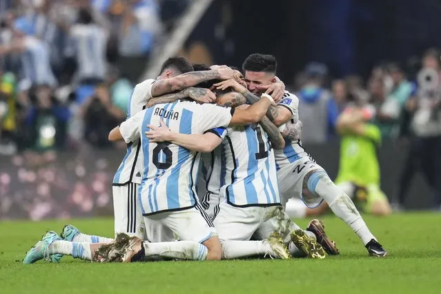 Argentina players celebrate winning the World Cup final soccer match between Argentina and France at the Lusail Stadium in Lusail, Qatar, Sunday, December 18, 2022. (Photo by Manu Fernandez/AP Photo)