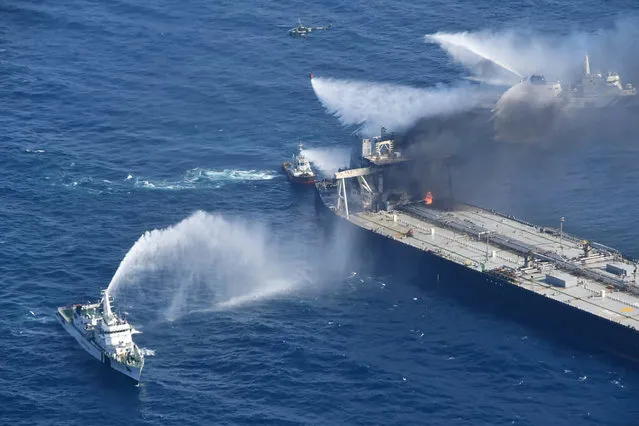 In this photo provided by Sri Lanka Air Force, tug boats and ships battle the fire on MT New Diamond, off the eastern coast of Sri Lanka in the Indian Ocean, Saturday, September 5, 2020. The fire on the large oil tanker off Sri Lanka's coast has been brought under control but is still not extinguished, the navy said Saturday. The tanker, carrying nearly 2 million barrels of crude oil, was drifting about 20 nautical miles (37 kilometers) from Sri Lanka's eastern coast and on Friday evening a tug boat towed it to the deep sea away from land, said navy spokesman Capt. Indika de Silva. (Photo by Sri Lanka Air Force via AP Photo)