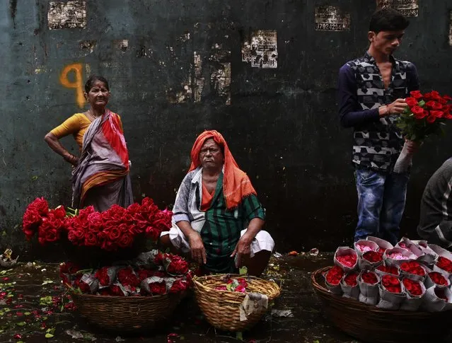 Indian flower venders look on as they wait for customers at a market in Mumbai, India, Thursday, September 22, 2016. (Photo by Rafiq Maqbool/AP Photo)