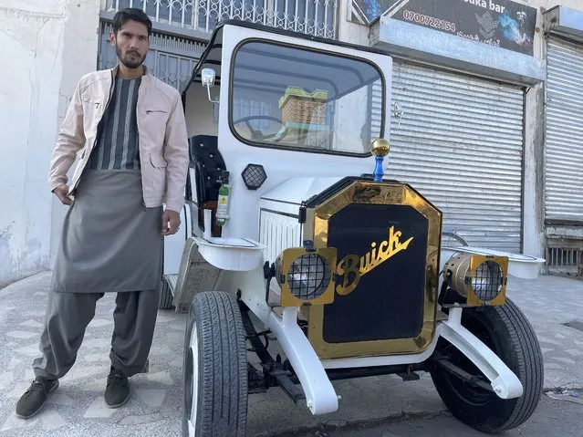 One of the brothers pose with the car that they have produced by themselves in Kandahar, Afghanistan on December 24, 2022. The brothers have managed to make their childhood dream come true and produce a car resembling a classic American car, Buick 1910, with a capacity to carry up to 500 kilograms. The 5-geared car costed around 4 thousand dollars and 2 years of elbow grease, and can drive up to 250 kilometers with a tank of gasoline. (Photo by Murteza Khaliqi/Anadolu Agency via Getty Images)