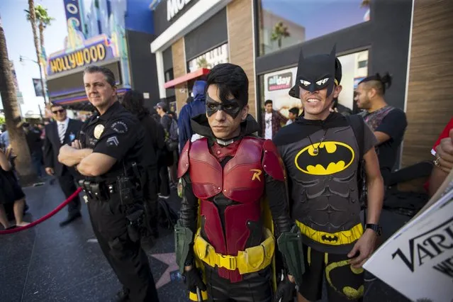 Fans dressed as Batman and Robin wait to watch a ceremony posthumously unveiling the star of Batman creator Bob Kane on the Hollywood Walk of Fame in Los Angeles, California October 21, 2015. (Photo by Mario Anzuoni/Reuters)