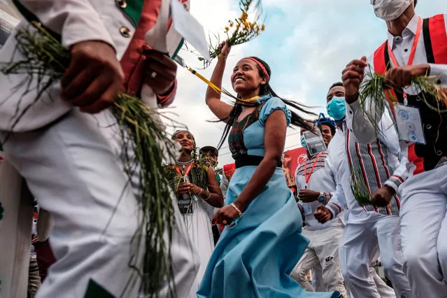 People wearing traditional clothing sing and dance during the celebration of “Irreechaa”, the Oromo people thanksgiving holiday, in Addis Ababa, Ethiopia, on October 3, 2020. Members of Ethiopia's largest ethnic group gathered under heavy security in Addis Ababa for a scaled-back version of their annual thanksgiving festival against a backdrop of unrest and political division. (Photo by Eduardo Soteras/AFP Photo)