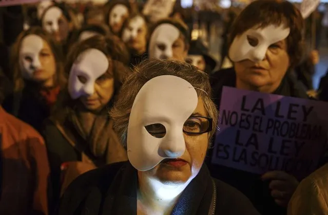 Women wear masks representing women killed by their partners, during a protest to mark the International Day for the Elimination of Violence against Women in Madrid November 25, 2014. (Photo by Sergio Perez/Reuters)