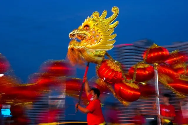 A dragon dance performance is seen ahead of the Lunar New Year celebration in Bangkok, Thailand, on January 18, 2023. (Photo by Athit Perawongmetha/Reuters)