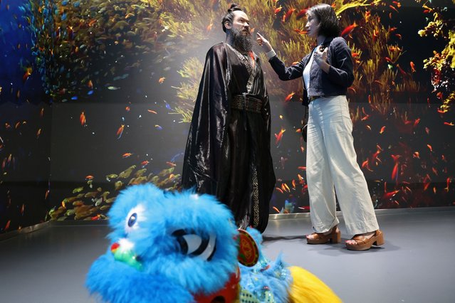 A media member looks at a humanoid robot portraying the Qin emperor Qin Shi Huang, during an organised media tour to Robot Mall, a store selling humanoid and other robots, in Beijing, China on August 6, 2025. (Photo by Florence Lo/Reuters)
