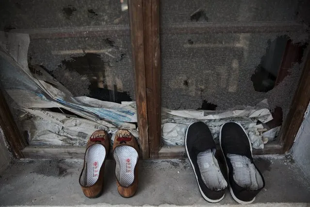 Two pairs of shoes are left on the windowsill of a building used by patients and their relatives at Yangjia Hospital in Wuyi County, Zhejiang Province, China October 19, 2015. (Photo by Damir Sagolj/Reuters)