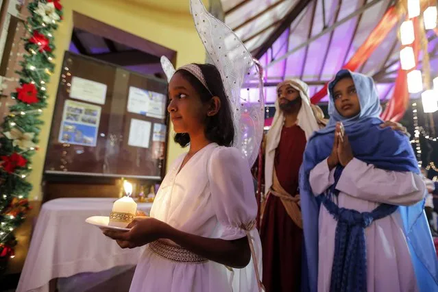 Sri Lankan Catholic children reenact the Nativity scene during the Christmas Eve midnight mass at the Christ King Church in the Pannipitiya suburb of Colombo, Sri Lanka, 25 December 2022. There are approximately 1.4 million Catholics in Sri Lanka, representing about 7.1 percent of the total population. (Photo by Hamila Karunarathne/EPA/EFE)