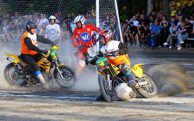Team members play motoball during a match between a local club consisting of miners of the Komsomolets Donbassa coal mine and a club representing Russia's Vladimir region, as participants mark Miners' Day amid Russia-Ukraine military conflict, in Kirovske (Khrestivka) in the Donetsk region, a Russian-controlled area of Ukraine, on August 31, 2025. (Photo by Alexander Ermochenko/Reuters)