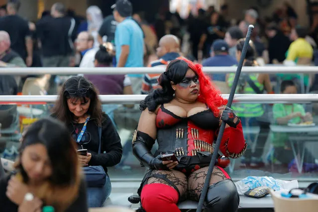 A woman in costume sits in the food court at New York Comic Con in Manhattan, New York, U.S., October 8, 2016. (Photo by Andrew Kelly/Reuters)