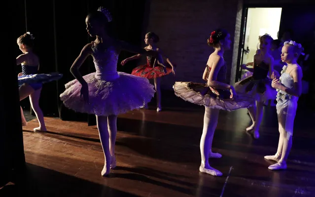 Young ballet dancers warm up for the Youth America Grand Prix regional semifinals at Dominican University Performing Arts Center in River Forest, Ill., Friday, January 19, 2018. The organization awards more than $250,000 a year in scholarships to send young dancers to leading schools and dance companies to continue their training. (Photo by Nam Y. Huh/AP photo)