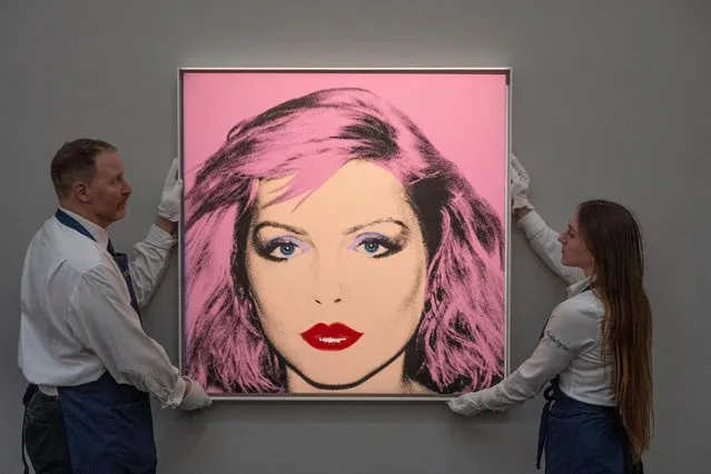 An art handler holds a portrait by Andy Warhol, Debbie Harry (est. £4-6 million) during a photo call for the upcoming Modern and Contemporary Evening Auction at Sothebyâs auction house in London, United Kingdom on February 22, 2023. Beginning with the innovations of the Impressionists, Sothebyâs Modern and Contemporary Evening Auction taking place on 1 March spans the birth of Modernism in the early twentieth century through to the evolution of Abstraction and Pop Art. (Photo by Malcolm Park/Alamy Live News)