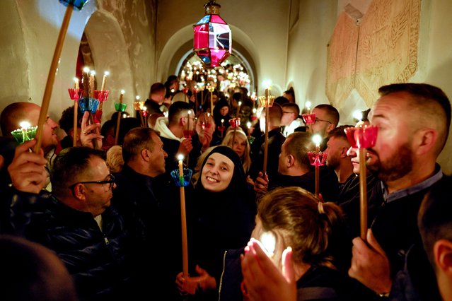 Christian Orthodox nuns hold candles and sing as they celebrate the resurrection of Jesus Christ during the Orthodox Christian Easter service at the 10th-century monastery St. John the Baptist (Sv. Jovan Bigorski) near Mavrovo, Republic of North Macedonia, 05 May 2024. North Macedonia's Orthodox church celebrates Easter by the Julian calendar. (Photo by Georgi Licovski/EPA)