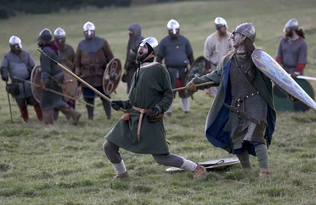 Re-enactors participate in a demonstration before a re-enactment of the the Battle of Hastings on the 950th anniversary of the battle, in Battle, Britain October 15, 2016. (Photo by Neil Hall/Reuters)