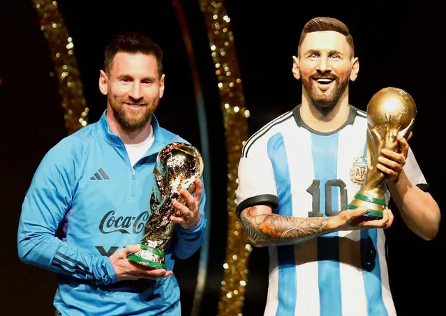 Argentina's forward Lionel Messi stands next to a statue of himself during a tribute by Conmebol to Argentina for their Qatar 2022 World Cup title, held before the draw for the Libertadores and Sudamericana football tournaments group phases, at Conmebol's headquarters in Luque, Paraguay, on March 27, 2023. (Photo by Cesar Olmedo/Reuters)