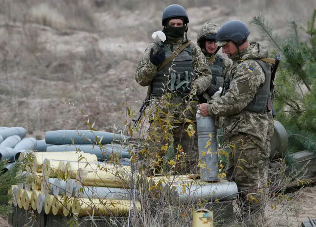 Ukrainian servicemen prepare shells during military exercises near the village of Divychky in Kiev region, Ukraine, October 21, 2016. (Photo by Valentyn Ogirenko/Reuters)