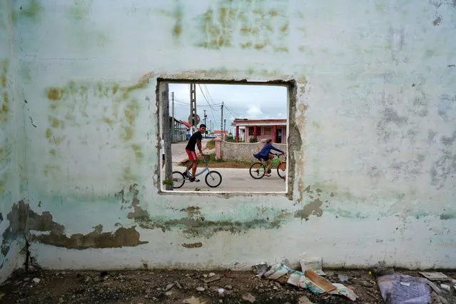 Children riding bicycles pass by an abandoned building in Isabela de Sagua, Cuba, January 28, 2023. This far-flung peninsula - on Cuba's north-central coast just 130 miles (210 km) south of the Florida Keys – is poised to once again become a barometer for measuring the impact of U.S. immigration policy, say residents, who for decades have watched the ebb and flow of migrants from the town's sand- and mangrove-lined shores. The latest twist: A U.S. “parole” program announced in early January that allows up to 30,000 migrants from Cuba and some other countries to enter the United States each month provided they apply online, find a financial sponsor and pay airfare. “Everyone is talking about it”, said Carlos Hernandez, a 49-year fisherman. He told Reuters the town was fast losing its population, fleeing the worst economic crisis to hit the country in decades. “People here are desperate to leave”. (Photo by Alexandre Meneghini/Reuters)