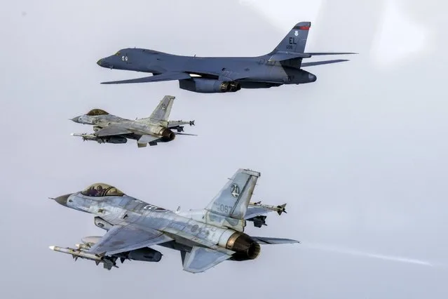 In this photo provided by South Korea Defense Ministry, a U.S. Air Force B-1B bomber, top, flies in formation with South Korea's Air Force KF-16 fighters over the South Korea Peninsula during a joint air drill in South Korea, Friday, March 3, 2023. The South Korean and U.S. militaries said Friday they'll go ahead with large-scale annual military drills later this month despite North Korea's threats to take “unprecedently” strong action against such training. (Photo by South Korea Defense Ministry via AP Photo)