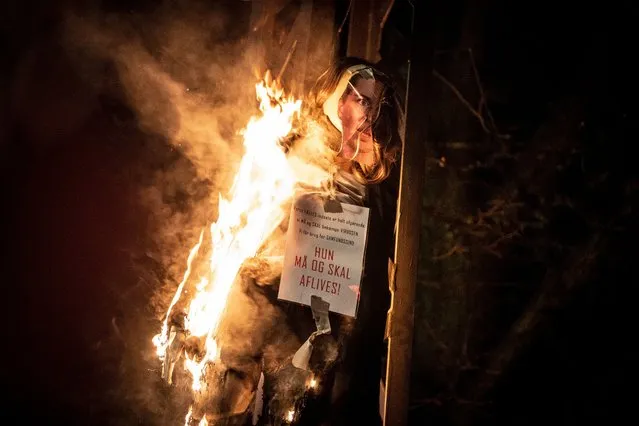 An effigy representing Danish Prime Minister Mette Frederiksen with a sign around her neck reading 'She must be put down' is set alight by protesters during a demonstration organized by a group calling itself “Men in Black”, in Copenhagen, Denmark, 23 January 2021 (issued 24 January 2021). The burning of the effigy provoked indignation among several Danish politicians, local media reported. Protesters took to the streets of the Danish capital against pandemic restrictions as well as against coronavirus disease (COVID-19) vaccinations. (Photo by Mads Claus Rasmussen/EPA/EFE)