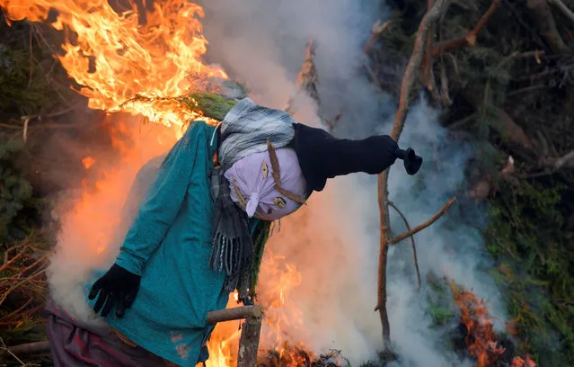 A puppet burns on Saint Walpurga's Eve, a tradition said to “ward off evil spirits and witches”, in Grossharthau, Germany on April 30, 2022. (Photo by Matthias Rietschel/Reuters)