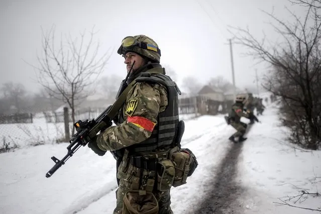 Ukrainian servicemen patrol Orekhovo village in Luhansk region January 28, 2015. Russia said on Wednesday military action by Ukrainian government forces would lead to an “inevitable further escalation of the conflict” in eastern Ukraine and undermine peace efforts. (Photo by Maksim Levin/Reuters)