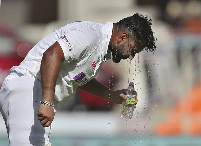 India's Rishabh Pant pours cold water on his head to beat the heat drinks water during the second day of fourth cricket test match between India and England at Narendra Modi Stadium in Ahmedabad, India, Friday, March 5, 2021. (Photo by Aijaz Rahi/AP Photo)