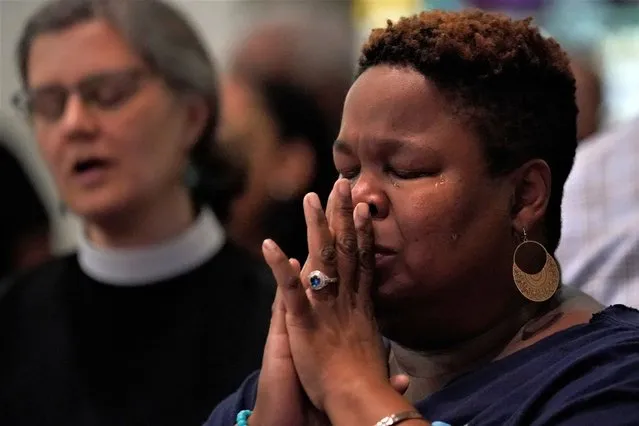 A woman cries while singing at a prayer vigil at Salt and Light church for the victims of a fatal shooting spree, Wednesday, July 5, 2023, in Philadelphia. The shooting occurred Monday night and left multiple people dead and others wounded. (Photo by Matt Slocum/AP Photo)