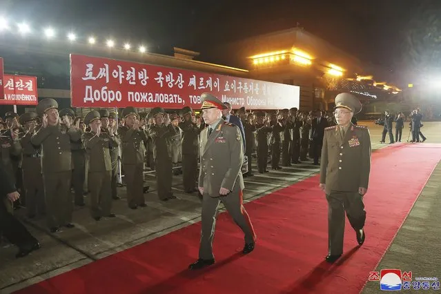 In this photo provided by the North Korean government,  Russian Defense Minister Sergei Shoigu, center, is welcomed by Korean People's Army members  at the Pyongyang International Airport in Pyongyang, North Korea Tuesday, July 25, 2023. Independent journalists were not given access to cover the event depicted in this image distributed by the North Korean government. The content of this image is as provided and cannot be independently verified. Korean language watermark on image as provided by source reads: “KCNA” which is the abbreviation for Korean Central News Agency. A banner means “We passionately welcome comrade Sergei Shoigu, defense minister of the Russian federation”. (Photo by Korean Central News Agency/Korea News Service via AP Photo)
