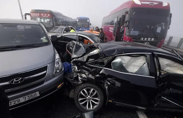Damaged vehicles sit on Yeongjong Bridge in Incheon, South Korea, Wednesday, February 11, 2015. Two people were killed and at least 42 were injured on Wednesday after a pileup involving about 100 vehicles in foggy weather on the bridge near the Incheon International Airport, South Korean officials said. (Photo by Suh Myung-gon/AP Photo/Yonhap)