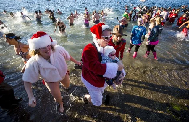 Participants take part during the 96th annual New Year's Day Polar Bear Swim in English Bay, Vancouver, British Columbia January 1, 2016. (Photo by Ben Nelms/Reuters)